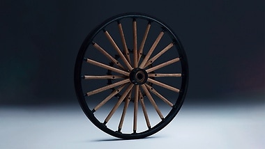 The wooden spoked wheel of the Daimler motorised carriage.